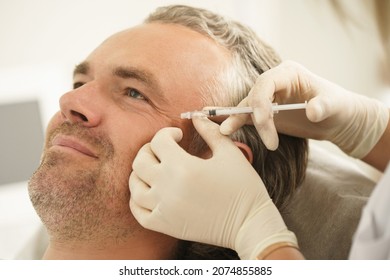 Middle Aged Male Client During Filler Injections In Aesthetic Medical Clinic