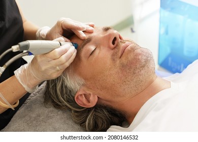 Middle Aged Male Client During Deep Facial Cleansing In A Cosmetology Clinic