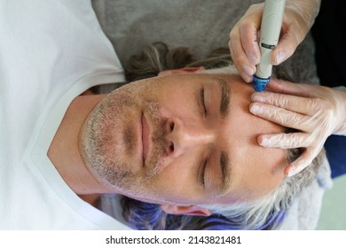 Middle Aged Male Client During Deep Facial Cleansing In A Cosmetology Clinic