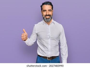 Middle Aged Man With Beard Wearing Casual White Shirt Smiling Happy And Positive, Thumb Up Doing Excellent And Approval Sign 