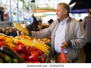 Middle Aged Man Buying Vegetables