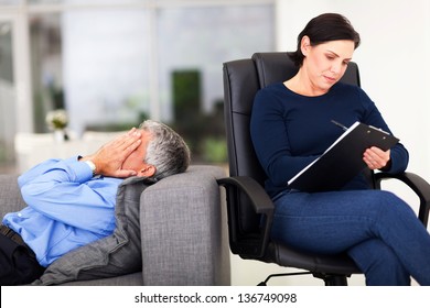 Middle Aged Man Crying During Session With Therapist In Office