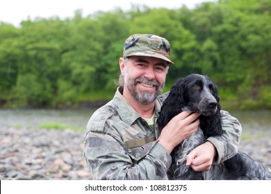 Middle Aged Man With A Dog (Russian Hunting Spaniel). At The River. Rain.