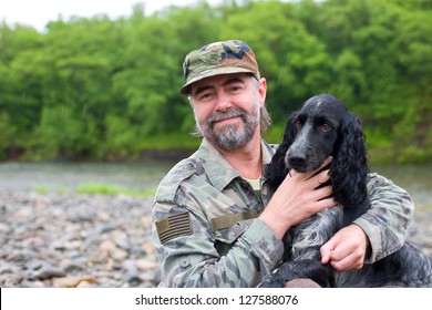 Middle Aged Man With A Dog (Russian Hunting Spaniel). At River In The Rain.