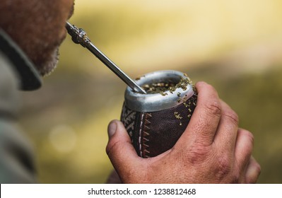 Middle aged man drinking yerba mate in nature. Travel and adventure concept. Latin American drink yerba mate.