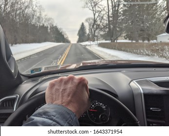 A Middle Aged Man Driving A Pickup Truck Down A Lonely Road.