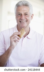 Middle Aged Man Eating Brown Bread Roll