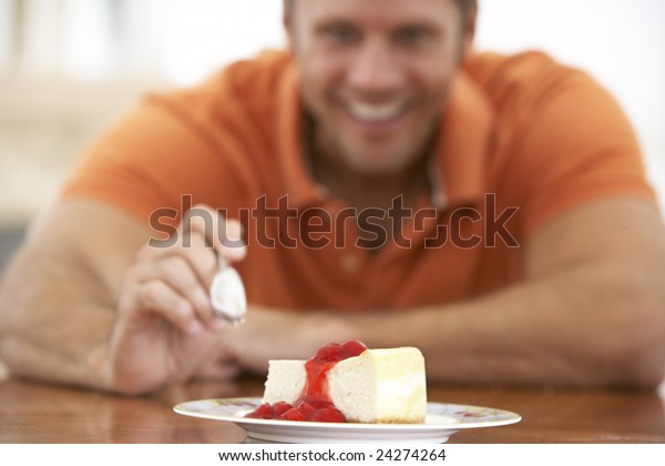 Middle Aged Man Eating Cheesecake Stock Photo Edit Now 24274264