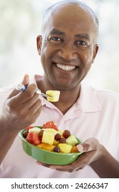 Middle Aged Man Eating Fresh Fruit Salad