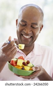 Middle Aged Man Eating Fresh Fruit Salad