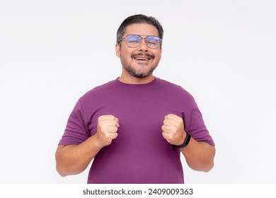 A middle aged man excited while visualizing his dream vacation. Eyes closed and smiling, feeling on cloud nine. Wearing a purple waffle shirt, Isolated on a white background.