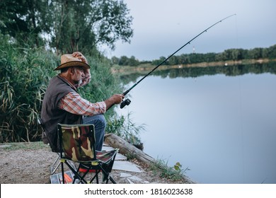 Middle Aged Man Fishing On The Lake