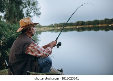 Middle Aged Man Fishing On The Lake