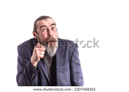 A middle aged man with a gray beard with a smoking pipe.Portrait of positive cheerful reliable freelancer.Old fashioned bearded hipster smoking pipe, isolated on white.