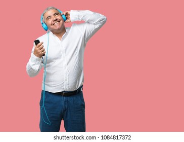 Middle Aged Man Happy And Fun, Listening To Music, Modern Headphones, Happy Feeling The Sound And Rhythm