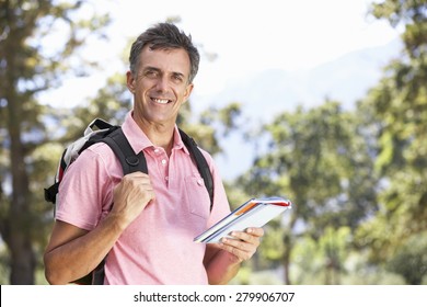 Middle Aged Man Hiking Through Countryside