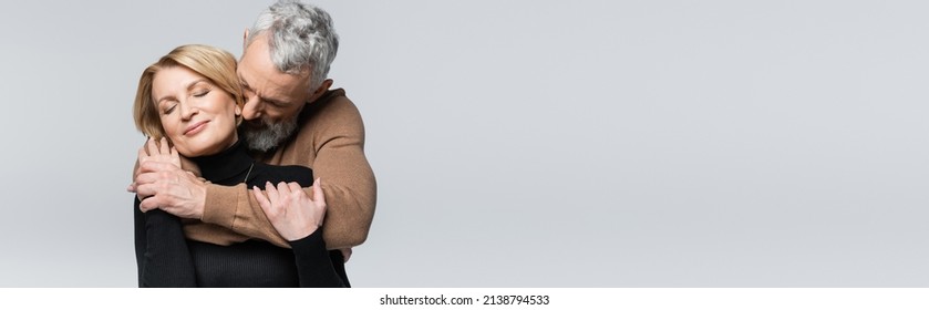 Middle Aged Man Hugging Blonde Wife Isolated On Grey, Banner