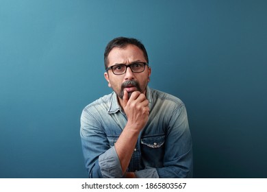 Middle aged man of Indian origin with a shocking face expression - Powered by Shutterstock