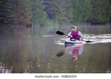 Middle Aged Man Kayak Fishing