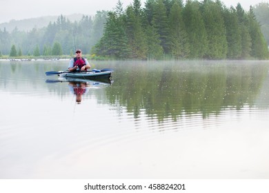 Middle Aged Man Kayak Fishing