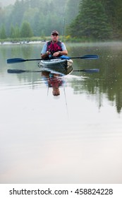 Middle Aged Man Kayak Fishing