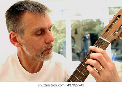 A Middle Aged Man Learning The Guitar