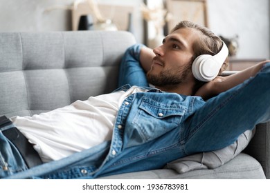 Middle aged man listening music with headphones relaxed in sofa at his home. - Powered by Shutterstock