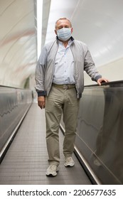 Middle Aged Man On Moving Walkway