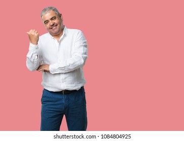 Middle Aged Man Pointing To The Side, Smiling Surprised Presenting Something, Natural And Casual