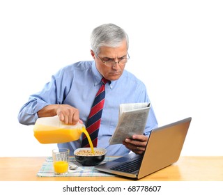 Middle aged man pouring Orange Juice into his breakfast cereal bowl instead of milk . He is in front of his laptop computer reading the morning newspaper. Horizontal format isolated over white. - Powered by Shutterstock