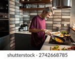 middle aged man preparing breakfast at home 