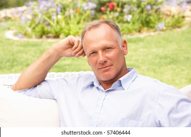 Middle Aged Man Relaxing In Garden