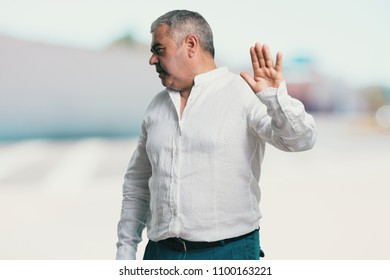 Middle Aged Man Serious And Determined, Putting Hand In Front, Stop Gesture, Deny Concept