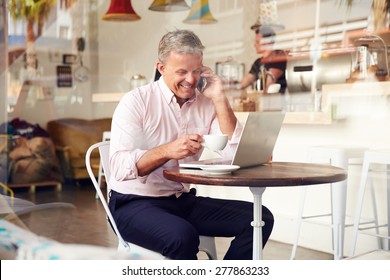 Middle aged man sitting in a cafe - Powered by Shutterstock