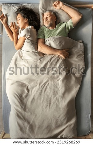 Similar – Image, Stock Photo Young couple in love embracing lying over a bed