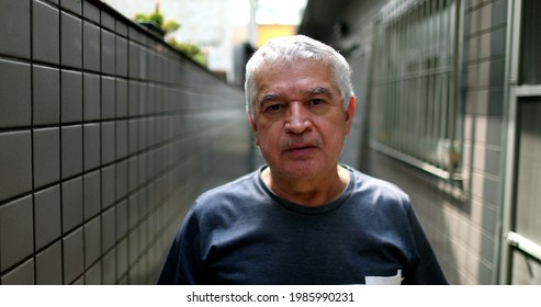 Middle Aged Man Standing Looking At Camera With Serious Expression Casual, Real People