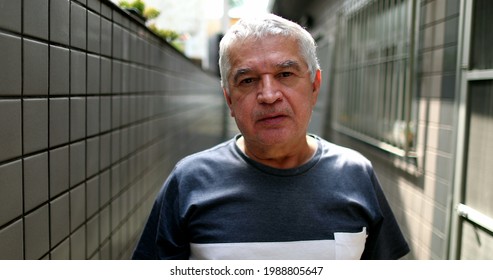 Middle Aged Man Standing Looking At Camera With Serious Expression Casual, Real People