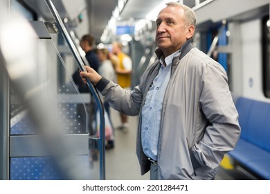 Middle aged man in subway car - Powered by Shutterstock