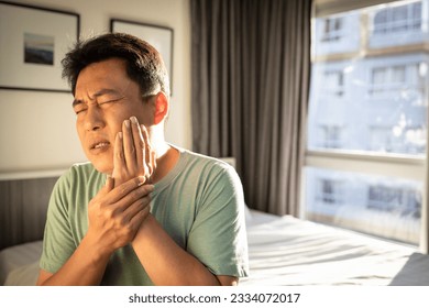 Middle aged man suffering from Gingivitis,Periodontitis,painful in gums and wisdom tooth around the molars,male have got very bad toothache,hyper-sensitive teeth,tooth root pain,dental caries problems - Shutterstock ID 2334072017
