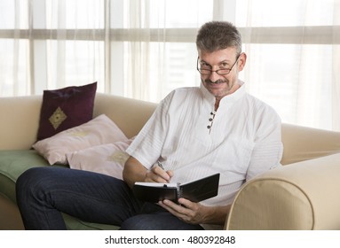 middle aged man taking notes - Shutterstock ID 480392848