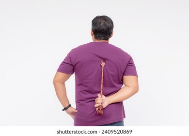 A middle aged man using a backscratcher to scracth and relieve an itch on his upper back. Rear view, isolated on a white background.