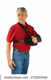 Middle Aged Man Wearing A Shoulder Surgery Sling With Abduction Pillow To Keep His Arm In The Proper Position During Recovery And Healing After His Operation.