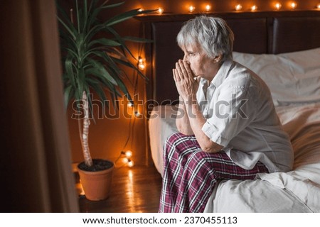 Middle aged mature woman insomniac lying awake in bed looking up trying to sleep, unhappy old senior lady feel disturbed frustrated suffer from insomnia concept uncomfortable bad mattress