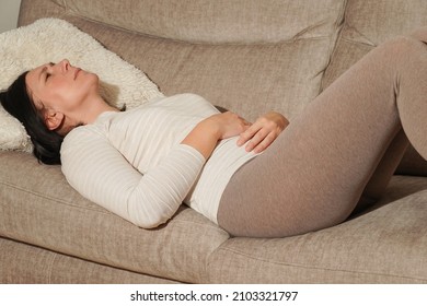 Middle Aged Mature Woman Suffering From Stomach Ache At Home. Abdominal Pain, Food Poisoning, Diarrhea, Stomach Ulcer, Menstruation Pain, Menopause.                                  