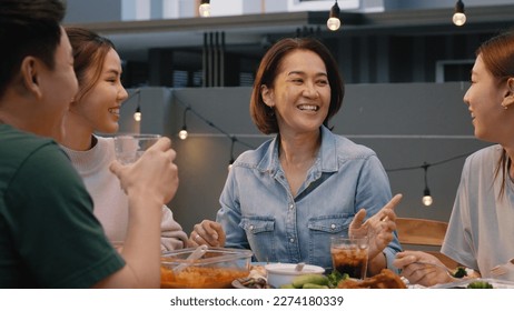 Middle aged mom fun talk smile at dine table home party. Asia people adult old mum enjoy food joy laugh happy hour at cozy picnic warm time on night meal weekend day. Young senior woman relax retired. - Powered by Shutterstock