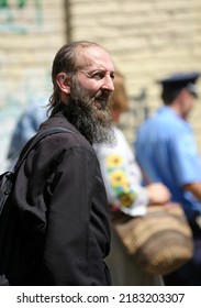 Middle Aged Monk In A Cassock Walking Down The Street, Portrait. July 28, 2019. Kyiv, Ukraine