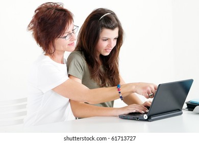 Middle Aged Mother Help Teen Daughter Studying Computer