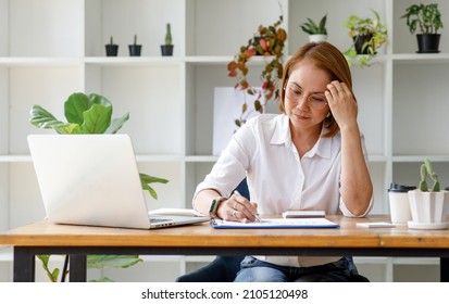 Middle Aged Older Asian Business Woman Watching Professional Training Class, Online Webinar On Laptop Computer Remote Working, Distance Learning In Office, Conference Calling In Virtual Chat Meeting.