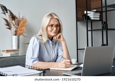 Middle aged older business woman watching professional training class, online webinar on laptop computer remote working, distance learning from home office, conference calling in virtual chat meeting.