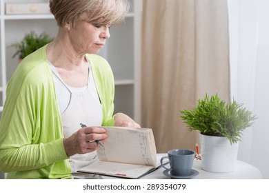 Middle Aged Organized Woman Looking At Her Calendar